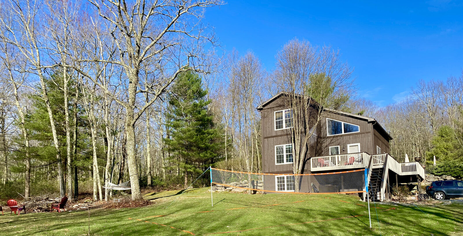 House exterior with yard games and hammock